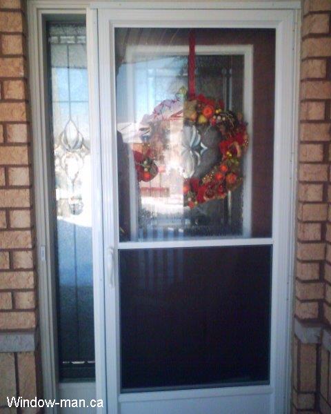 Custom stained glass inserts in existing front door. Beveled Glass with black caming. Self storing storm door